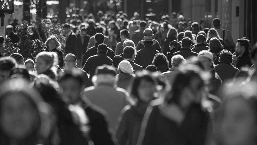 A busy urban street crowded with pedestrians.