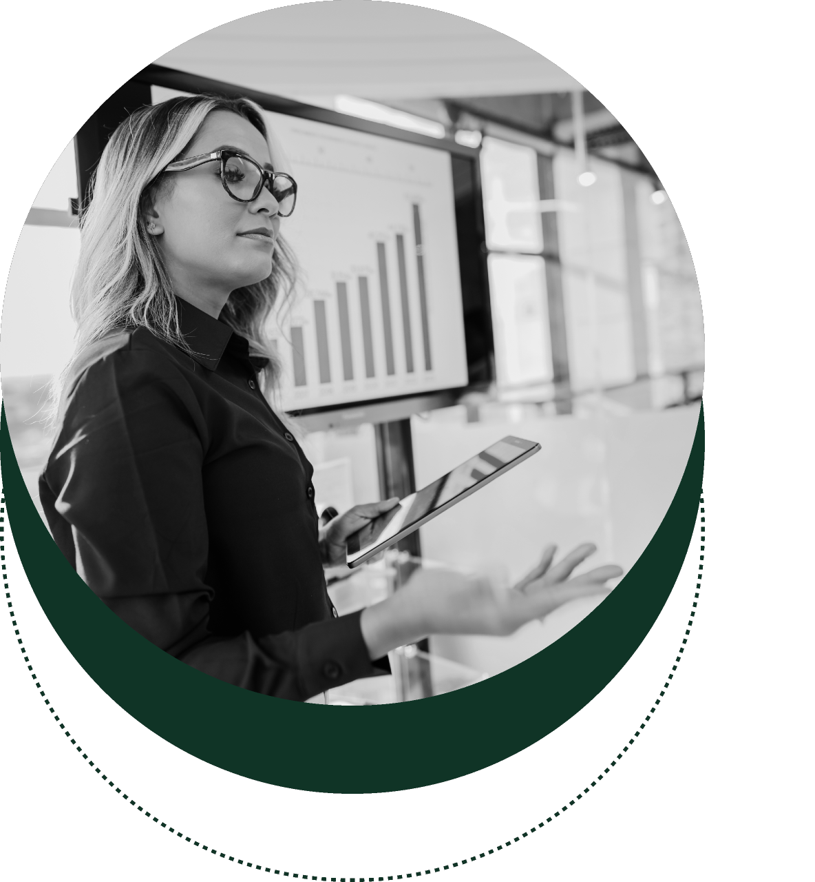 Woman holding a tablet and presenting in front of a bar chart on a screen.