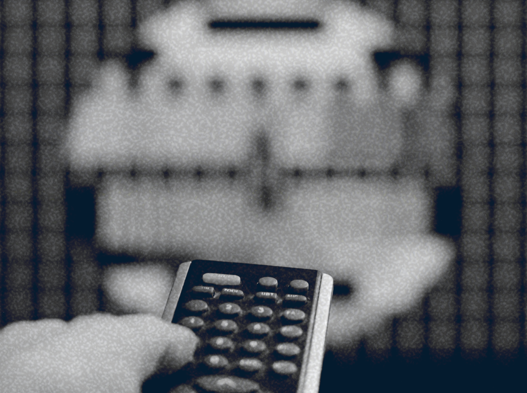 A hand holds a remote control pointing at a blurred television screen displaying a test pattern, hinting at the challenges of streaming media and modern subscriptions.